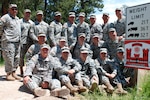Soldiers of the 1141st Sapper Company of the Missouri National Guard pose near a sign naming a bridge in Custer State Park near Rapid City, S.D., in honor of Sgt. Denis Kisseloff, a Missouri Guardsman who was killed in Afghanistan in May.