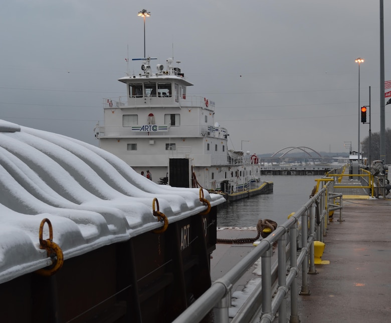 M/V New Dawn broke through Lake Pepin ice overnight and locked through Lock and Dam 2, near Hastings, Minnesota, around 7:45 on March 25, 2015, marking the unofficial start to the navigation season for the Upper Mississippi River. The American River Transportation Company boat was pushing nine barges loaded with fertilizer.