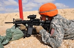 Spc. Tommy Ly, a financial management technician, assigned to the 1st Squadron, 112th Cavalry Regiment, Texas National Guard, currently serving under Task Force Sinai, Multinational Force and Observers, fires his M4 Carbine rifle downrange March 18, 2015, during the Task Force Sinai Soldier of the Quarter Competition held on North Camp in the Sinai Peninsula of Egypt.