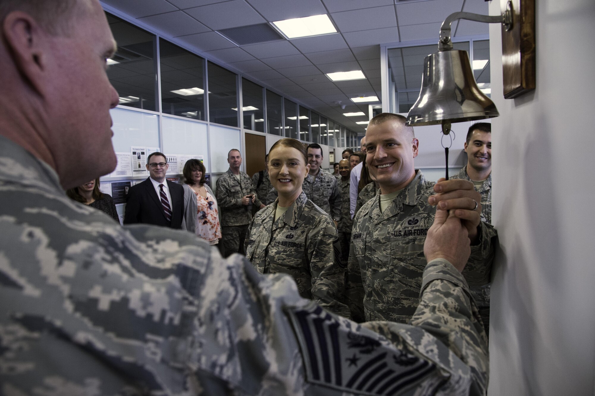 Chief Master Sgt. of the Air Force James Cody rings the victory bell with Airmen from the Air Force Legal Operations Agency March 23, 2015, during his visit to Joint Base Andrews, Md. The bell is rang when there is a legal victory in the office. (U.S. Air Force photo/Airman 1st Class Philip Bryant)