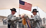 Col. Jeffrey Holmes, left, commander of the Tennessee National Guard's 278th Armored Cavalry Regiment, 103rd Sustainment Command (Expeditionary), and Command Sgt. Maj. Daniel Jennings, command sergeant major of the 278th ACR, case the unit’s colors during an end of mission ceremony at Contingency Operating Base Taji, Iraq June 27, 2010.