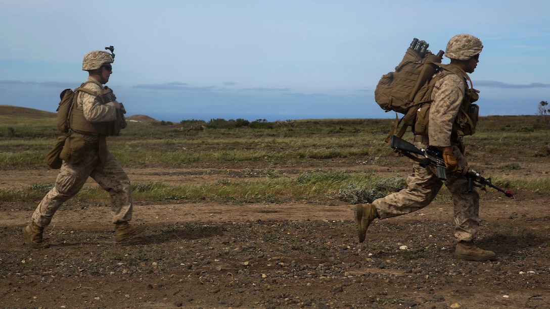 U.S. Marines with Lima Company, Battalion Landing Team 3rd Battalion, 1st Marine Regiment, 15th Marine Expeditionary Unit, run toward their objective during Composite Training Unit Exercise (COMPTUEX) on San Clemente Island, Calif., March 22, 2015. As part of the 15th MEU’s ground combat element, the Marines practiced their urban movement and room clearing skills in preparation for their deployment. (U.S. Marine Corps photo by Cpl. Anna Albrecht/Released)