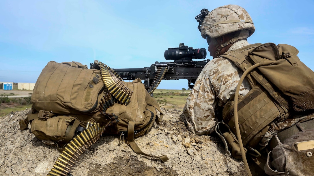 A U.S. Marine with Lima Company, Battalion Landing Team 3rd Battalion, 1st Marine Regiment, 15th Marine Expeditionary Unit, watches over the objective during an airfield seizure mission as part of Composite Training Unit Exercise (COMPTUEX) on San Clemente Island, Calif., March 22, 2015. These Marines inserted onto the island to execute a raid and practice their urban combat skills. (U.S. Marine Corps photo by Cpl. Anna Albrecht/Released)