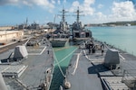 APRA HARBOR, Guam (Mar. 20, 2015) - The Arleigh Burke-class guided-missile destroyers USS Fitzgerald (DDG 62), left, USS Sampson (DDG 102), USS Curtis Wilbur (DDG 54), and USS Michael Murphy (DDG 112) are moored in Apra Harbor, Guam, for a port visit. In the background is the Ticonderoga-class guided-missile cruiser USS Antietam (CG 54). All five ships are on patrol in the U.S. 7th Fleet area of responsibility supporting security and stability in the Indo-Asia-Pacific region. 