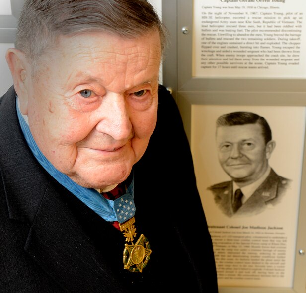 Retired Col. Joe Jackson poses with a permanent Medal of Honor display March 24, 2015, at the Pentagon in Washington D.C. The display depicts him and other medal recipients.  Jackson was in the Pentagon with fellow Medal of Honor recipient, retired Col. Leo Thorsness for a Q-and-A session with members of the Air Staff, hosted in the Hall of Heroes.  Jackson and Thorsness also met with Secretary of the Air Force Deborah Lee James and Air Force Vice Chief of Staff Gen. Larry Spencer.  (U.S. Air Force photo/Scott M. Ash)