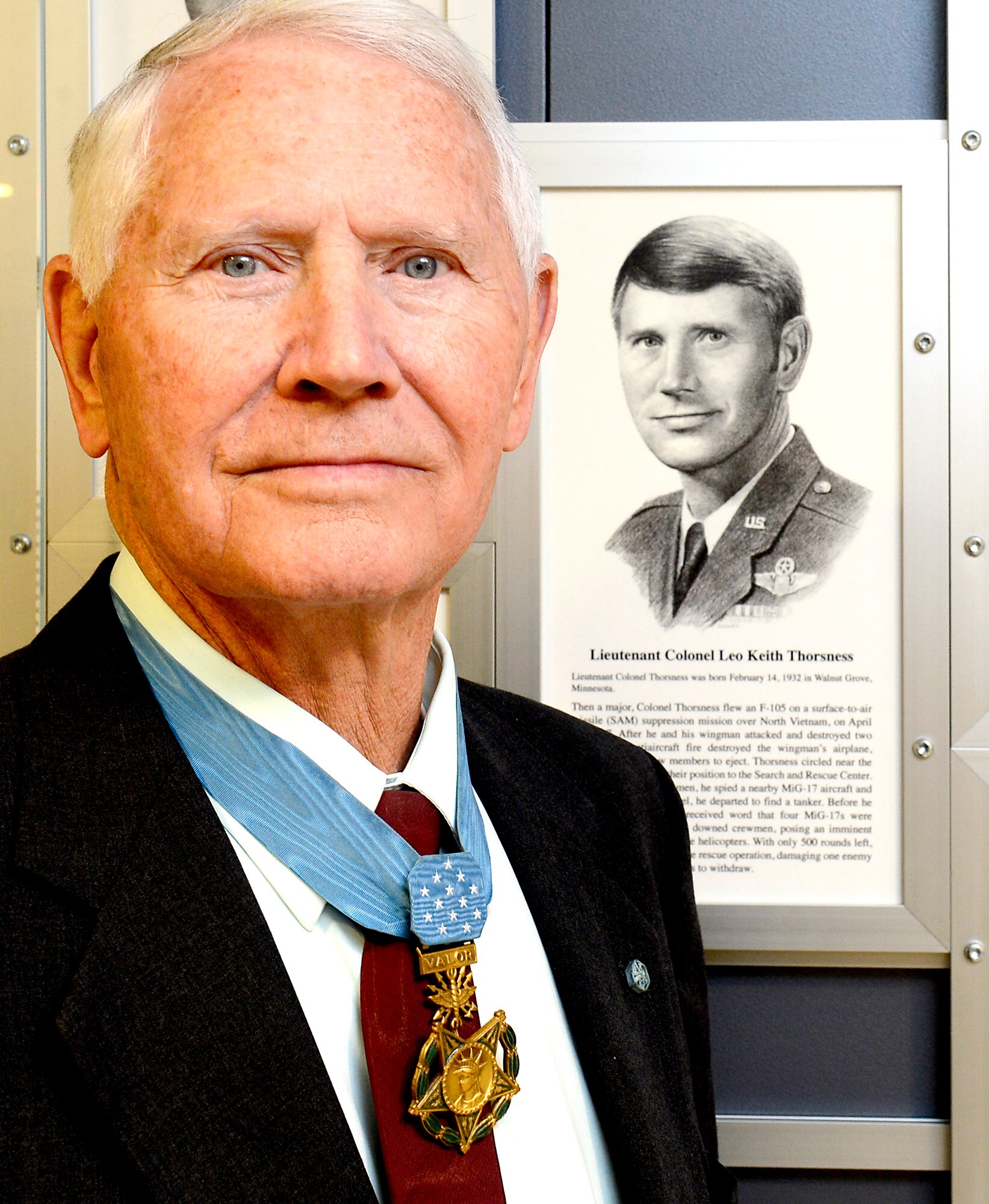 Retired Col. Leo Thorsness poses with a permanent Medal of Honor display March 24, 2015, at the Pentagon in Washington D.C. The display depicts him and other medal recipients.  Thorsness was in the Pentagon with fellow Medal of Honor recipient, Joe Jackson for a Q-and-A session with members of the Air Staff, hosted in the Hall of Heroes.  Jackson and Thorsness also met with Secretary of the Air Force Deborah Lee James and Air Force Vice Chief of Staff Gen. Larry Spencer.  (U.S. Air Force photo/Scott M. Ash) 
