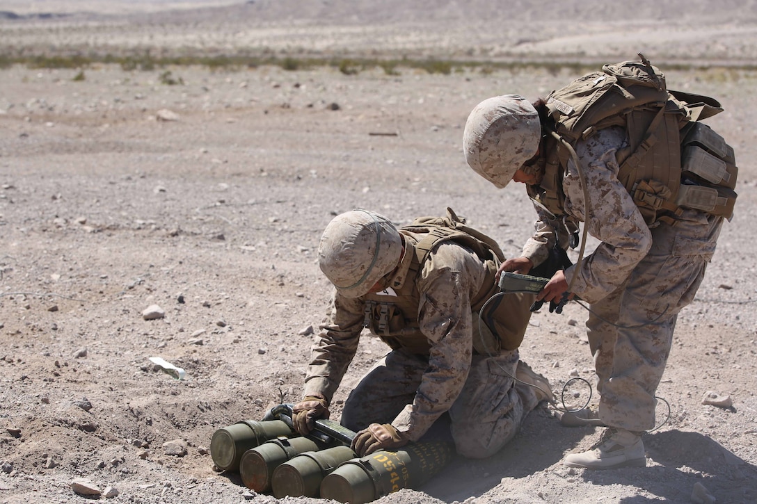 Cpl. Joshua J. Syverson, left, and Cpl. Alicia Hernandez, right, both combat engineers with Engineer Platoon, Headquarters and Service Company, Ground Combat Element Integrated Task Force, prepare C4 charges and detonation cord for cache reduction during a Marine Corps Operational Test and Evaluation Activity assessment at Range 107, Marine Corps Air Ground Combat Center Twentynine Palms, California, March 22, 2015. From October 2014 to July 2015, the GCEITF will conduct individual and collective level skills training in designated ground combat arms occupational specialties in order to facilitate the standards-based assessment of the physical performance of Marines in a simulated operating environment performing specific ground combat arms tasks. (U.S. Marine Corps photo by Cpl. Paul S. Martinez/Released)