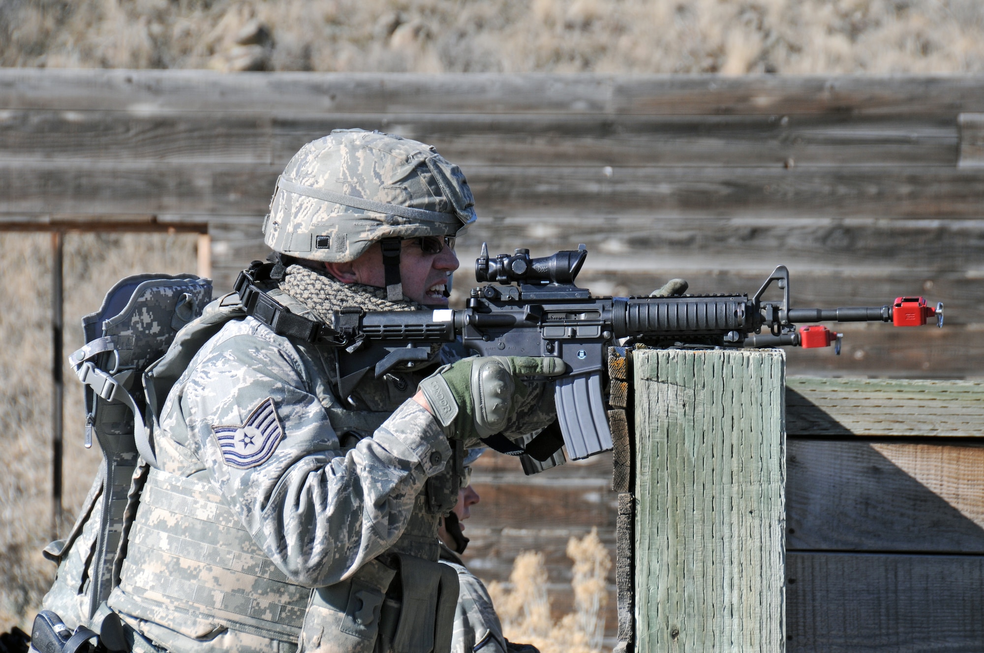 Tech. Sgt. Alan Robins, 151st Security Forces Squadron, participates in a 
simulated assault on a village during a training exercise on March 9, 2015 at 
the Military Operations in Urban Terrain Range at Camp Williams, Utah. (Air National Guard photo by Staff Sgt. Annie Edwards/RELEASED)