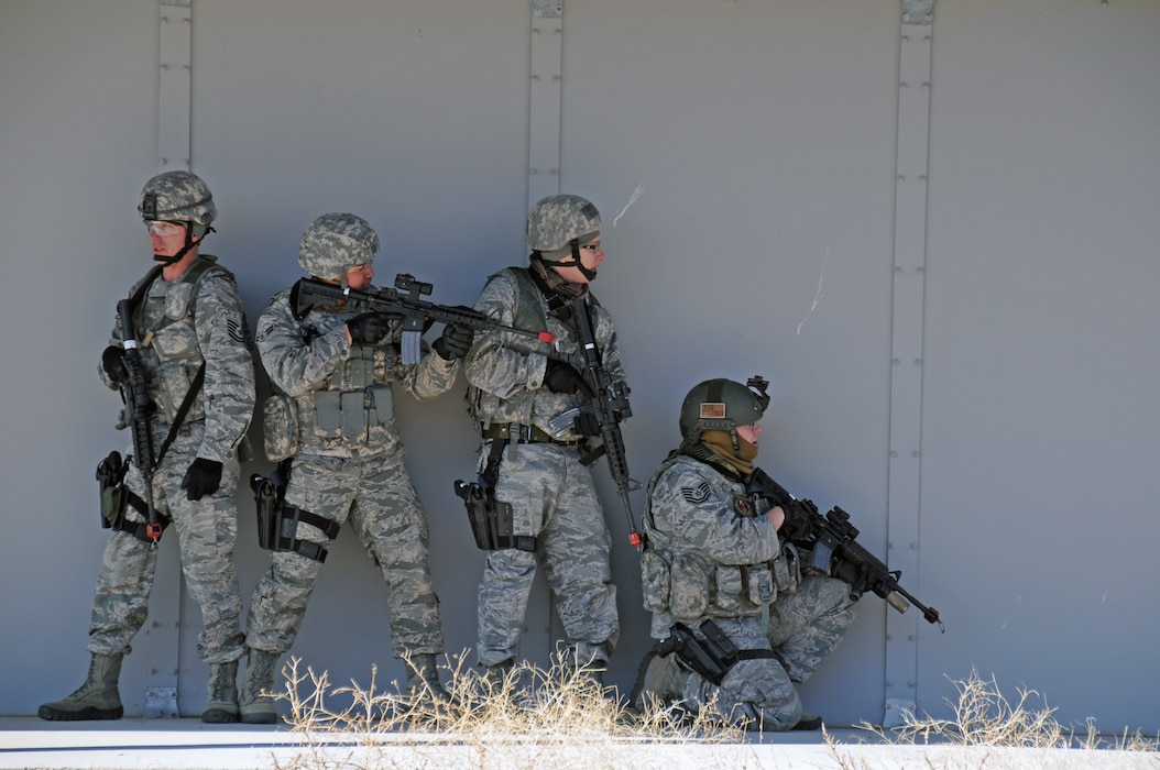 From left: Tech. Sgt. Casy Carsten, Airman 1st Class Adam Cazimero, Senior 
Airman Samuel Gudmundson, and Tech. Sgt. Nicholas Nelson, members of the 151st 
Security Forces Squadron, participate in a simulated assault on a village at 
the Military Operations in Urban Terrain Range at Camp Williams, Utah, on 
March 9, 2015. (Air National Guard photo by Staff Sgt. Annie Edwards/RELEASED)