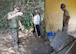 U.S. servicemembers and a Vietnam People's Army Defense member, middle, discuss the progress of preparing a site for pouring a concrete pad at Binh Thanh Dong primary school, Quang Ngai Province, Vietnam, during a Operation Pacific Angel 15-3 event, March 23, 2015. This is the fifth time PACANGEL has partnered with the host nation to provide humanitarian assistance and disaster relief in the region.  (U.S. Air Force photo by Staff Sgt. Tong Duong/ Released)