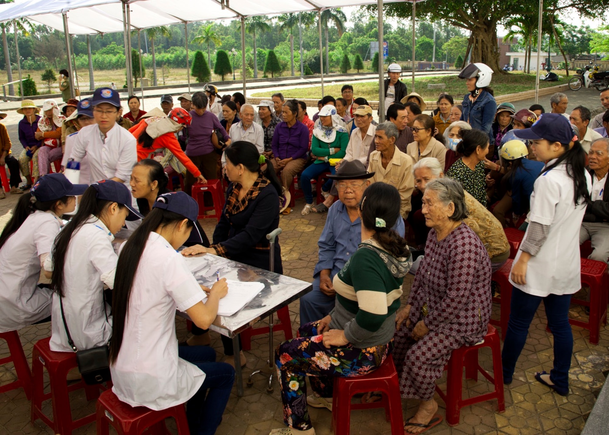 Vietnamese medical patient handlers register locals from Quang Ngai Province during a Operation Pacific Angel 15-3 health services outreach event at Dung Quat Culture - Sports Center, Quang Ngai Province, Vietnam, March 23, 2015. Operation PACANGEL is a total force, joint and combined humanitarian assistance operation led by the U.S. Pacific Air Forces. The operation promotes interoperability amongst U.S. military, host nation and multilateral military and civilian organizations. (U.S. Air Force photo by Staff Sgt. Tong Duong/ Released)
