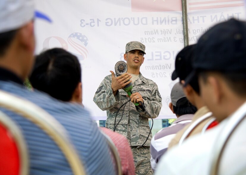 U.S. Air Force Tech. Sgt. Giles Dame, 18th Civil Engineer Squadron structural craftsman, Kadena Air Base, Japan, leads a work safety class with Vietnam People's Army Air Defense member at Binh Thanh Dong primary school, Quang Ngai Province, Vietnam, March 23, 2015 during a Operation Pacific Angel 15-3 event. Operation PACANGEL is a total force, joint and combined humanitarian assistance operation led by the U.S. Pacific Air Forces. The operation promotes interoperability amongst U.S. military, host nation and multilateral military and civilian organizations. (U.S. Air Force photo by Staff Sgt. Tong Duong/ Released)