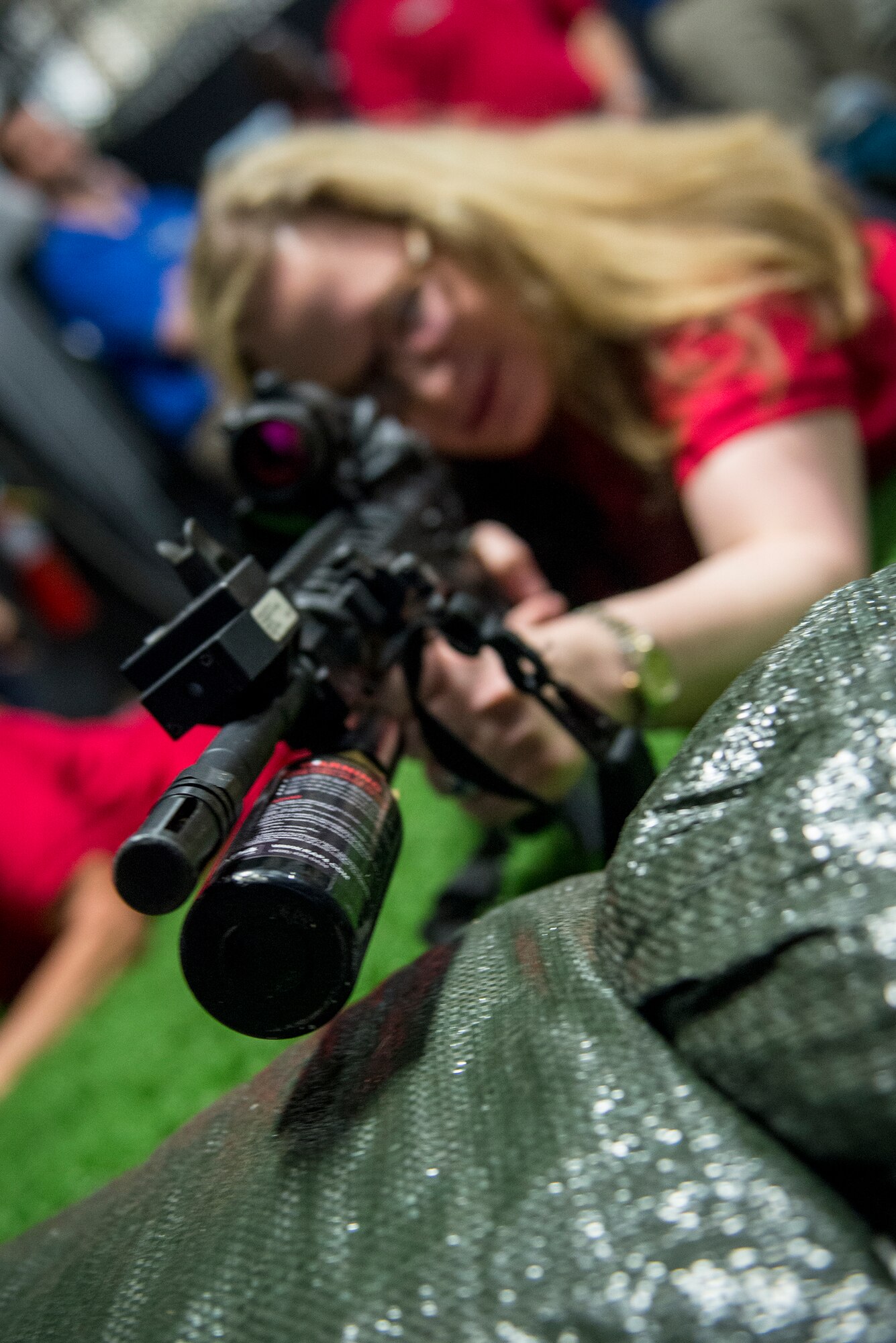 Betsy Thacker, member of the Leadership Lowndes Class of 2015, prepares to fire a simulated firearm during a base tour March 19, 2015 at Moody Air Force Base, Ga. Each participant had a chance to use the Engage Skills Trainer 2000, a training program used by the 820th Base Defense Group.  (U.S. Air Force photo by Andrea Jenkins/Released)

