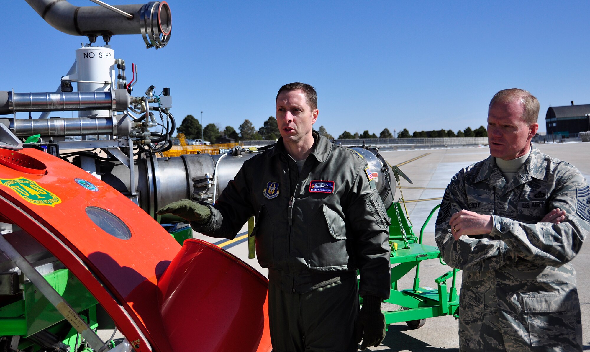 PETERSON AIR FORCE BASE, Colo. –Lt. Col. Robert Fairbanks, a C-130 Modular Airborne Fire Fighting System aircraft commander, left, explains to Chief Master Sgt. of the Air Force James A. Cody the capabilities of the system during Cody’s visit with the 302nd Airlift Wing. The U.S. Forest Service portable MAFFS can be loaded onto a C-130 to assist with wildland firefighting efforts. Cody spent the March 2015 Unit Training Assembly with the Reserve wing to talk to Airmen and address any questions or concerns they have. (U.S. Air Force photo/Master Sgt. Daniel Butterfield)