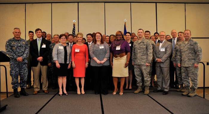 Commanders from across the installation pose for a group photo following the induction of the newest Honorary Commanders March 25, 2015 at The Charleston Club on Joint Base Charleston, S.C. The Honorary Commanders program is a civic outreach initiative, which allows community partners to gain awareness of the military mission and allows their military counterparts to learn more about the communities surrounding the base. (U.S. Air Force photo/Tech. Sgt. Renae Pittman)