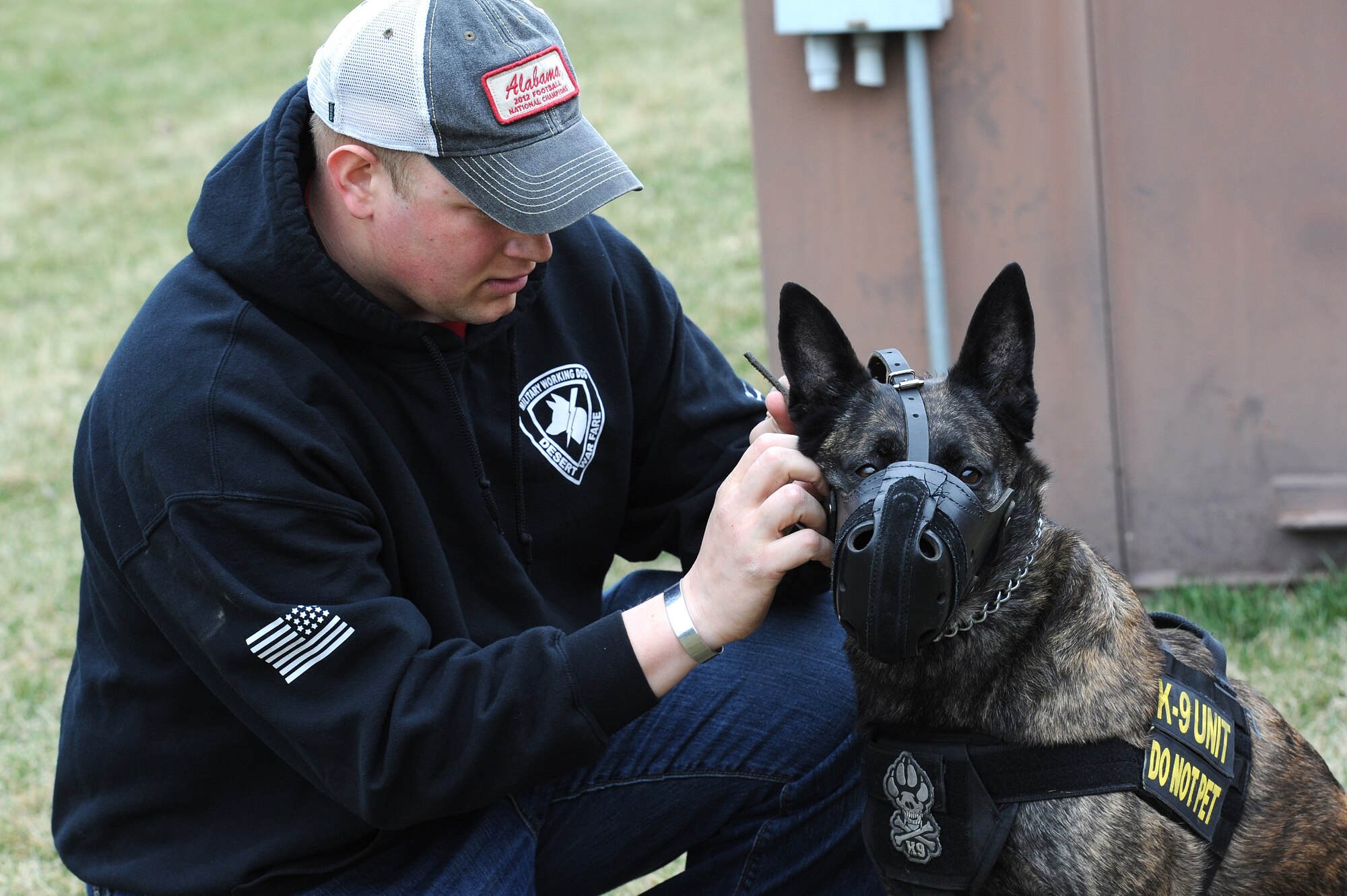 Staff. Sgt. David Yaronczyk, 375th Security Forces Squadron military working dog handler, places a muzzle on Fay, 375th SFS military working dog, before muzzle aggression training March 20, 2015, at the 375th SFS Military Working Dog Kennels at Scott Air Force Base, Ill. To improve a MWDs skills they must constantly train and be pushed to the next level.  (U.S. Air Force photo/ Senior Airman Tristin English)