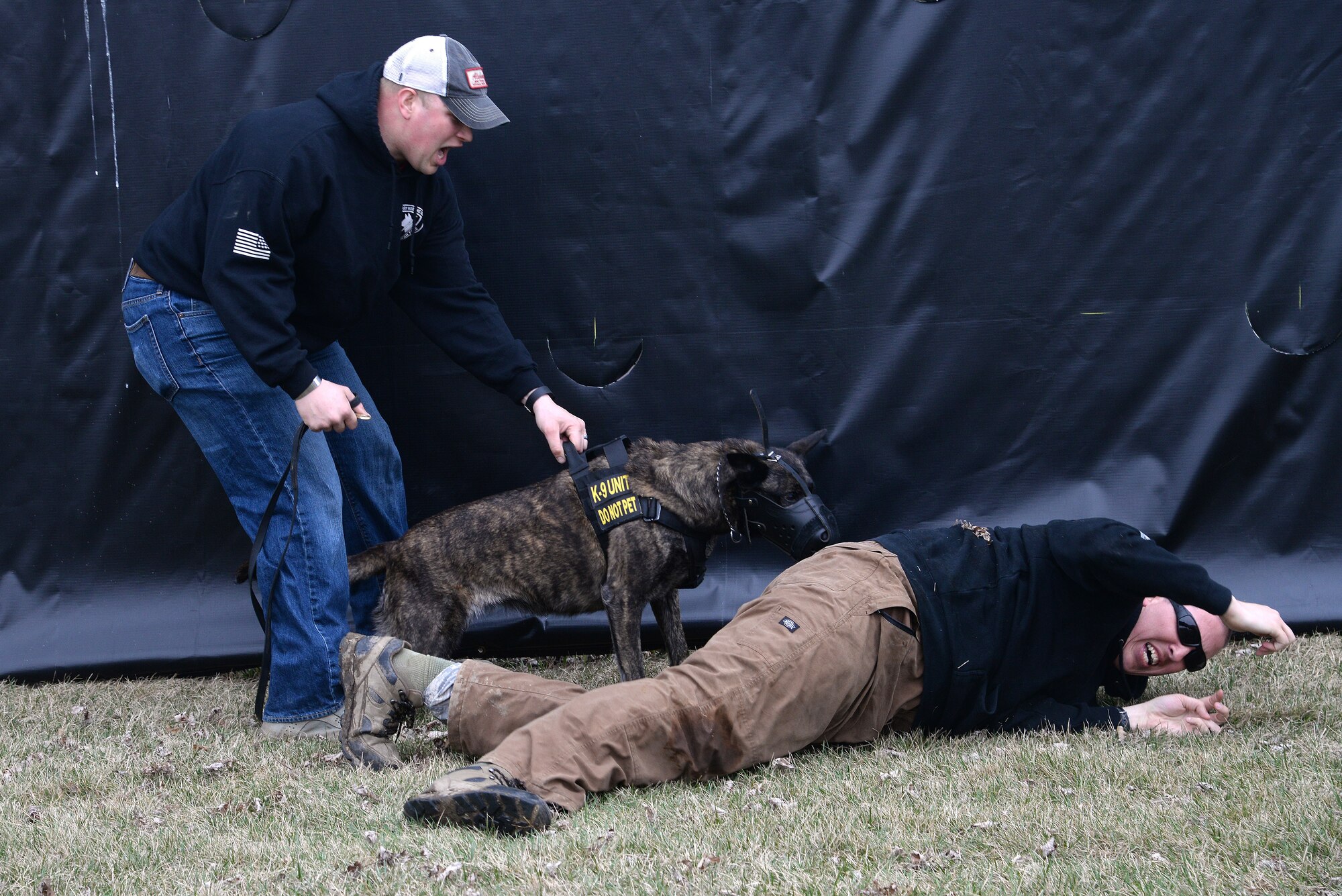 Staff. Sgt. David Yaronczyk, 375th Security Forces Squadron military pulls Fay, 375th SFS military working dog, off of Tech. Sgt. Bryan Dell, 375th SFS NCOIC military working dog section, during muzzle aggression training March 20, 2015, at the 375th SFS Military Working Dog Kennels at Scott Air Force Base, Ill. MWDs are trained at Lackland AFB where they go through a 120 day basic training course, then they are trained continuously throughout their career by the handlers and trainers. (U.S. Air Force photo/ Senior Airman Tristin English)