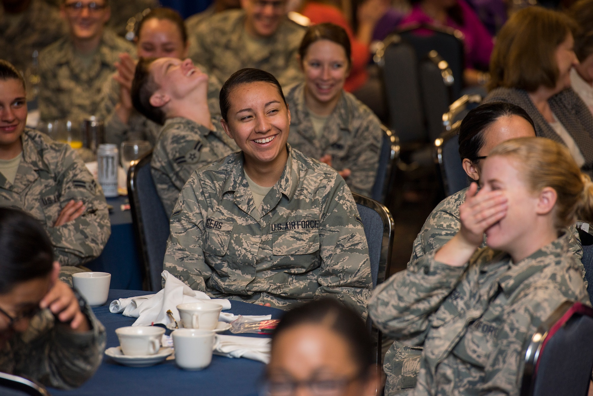 U.S. Air Force Airmen from Sheppard Air Force Base, Texas, laugh during the first Women’s Conference, March 24, 2015. Speakers at the conference shared a variety of stories and speeches. The speeches aimed to bring awareness to domestic violence, health and well-being, diversity, healthy relationships and support programs. (U.S. Air Force photo by Senior Airman Kyle Gese/Released)