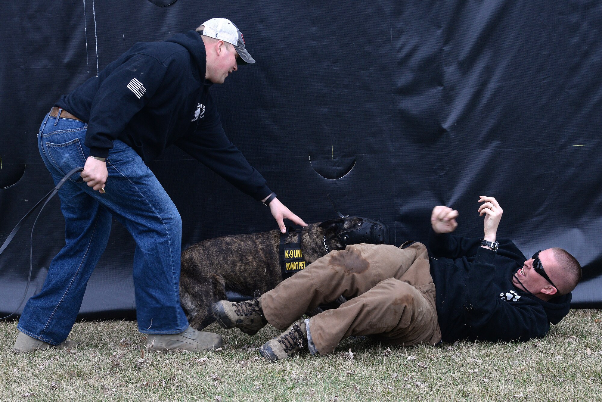 Staff. Sgt. David Yaronczyk, 375th Security Forces Squadron military pulls Fay, 375th SFS military working dog, off of Tech. Sgt. Bryan Dell, 375th SFS NCOIC military working dog section, during muzzle aggression training March 20, 2015, at the 375th SFS Military Working Dog Kennels at Scott Air Force Base, Ill. MWDs are trained at Lackland AFB where they go through a 120 day basic training course, then they are trained continuously throughout their career by the handlers and trainers. (U.S. Air Force photo/ Senior Airman Tristin English)