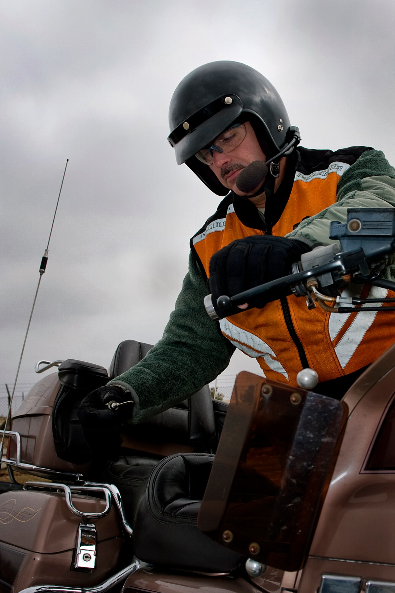Tech. Sgt. John Thompson, 434th Aircraft Maintenance Squadron crew chief, checks his motorcycle's engine oil while demonstrating a pre-ride inspection at Grissom Air Reserve Base, Ind., March 20, 2015. Pre-ride inspections are one of many risk management tools that can be used to help ensure a rider's motorcycle is ready for Spring riding. (U.S. Air Force photo/Tech. Sgt. Benjamin Mota) 