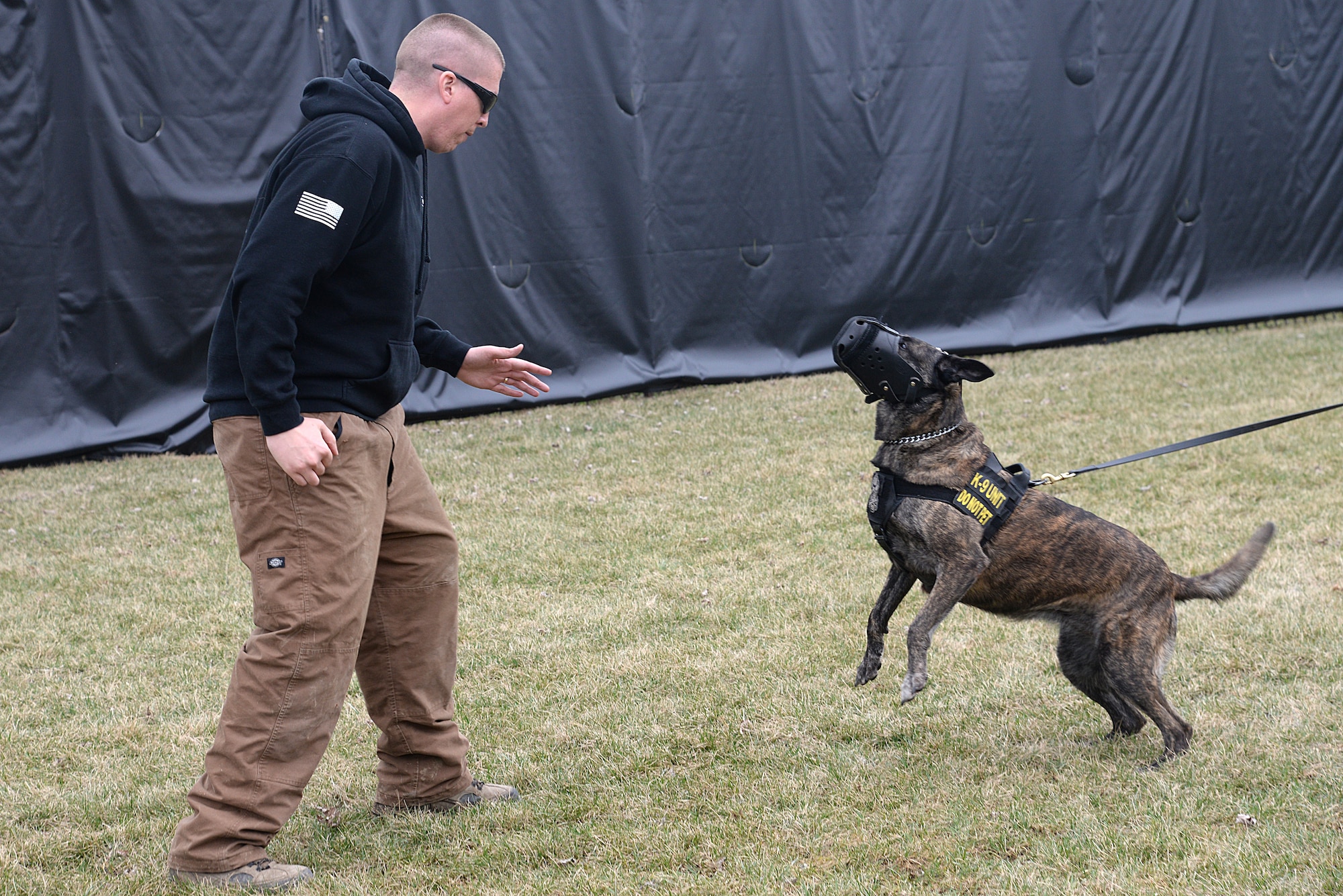Tech. Sgt. Bryan Dell, 375th Security Forces Squadron NCOIC military working dog section, antagonizes Fay, 375th SFS military working dog, during muzzle aggression training March 20, 2015, at the 375th SFS Military Working Dog Kennels at Scott Air Force Base, Ill. Muzzle aggression training helps to protect an individual when the MWD is released. (U.S. Air Force photo/ Senior Airman Tristin English)