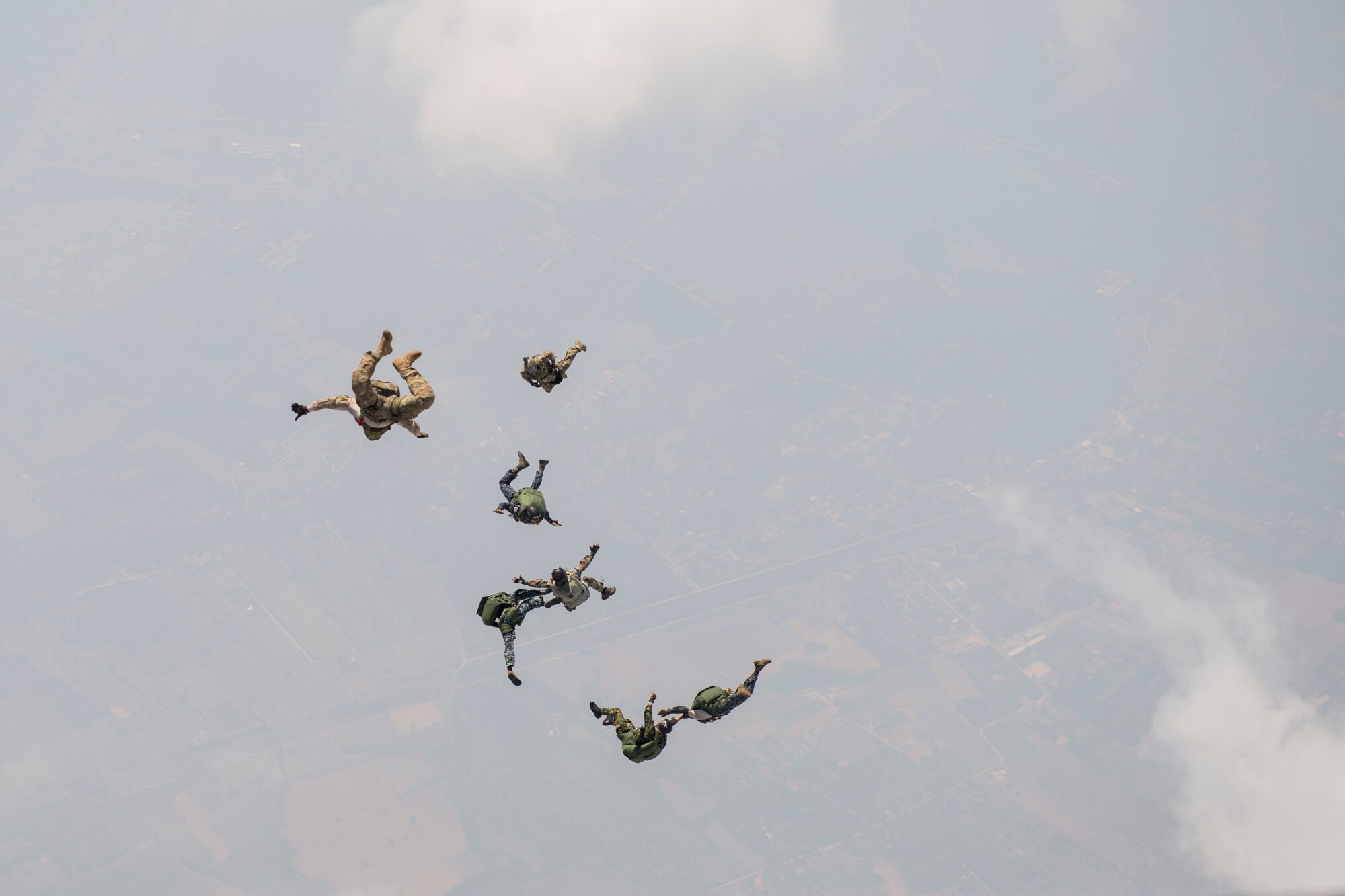 U.S. and Thai air forces conduct a High Altitude Low Opening jump from a U.S. C-130 during Exercise Cope Tiger 15 near Udon, Thailand, March 11, 2015. CT15 includes 22 total flying units and over 1,390 personnel from three countries and continues the growth of strong, interoperable and beneficial relationships within the Asia-Pacific region through integration of airborne and land-based command and control assets. (U.S. Air Force photo by Airman 1st Class Taylor Queen/Released)