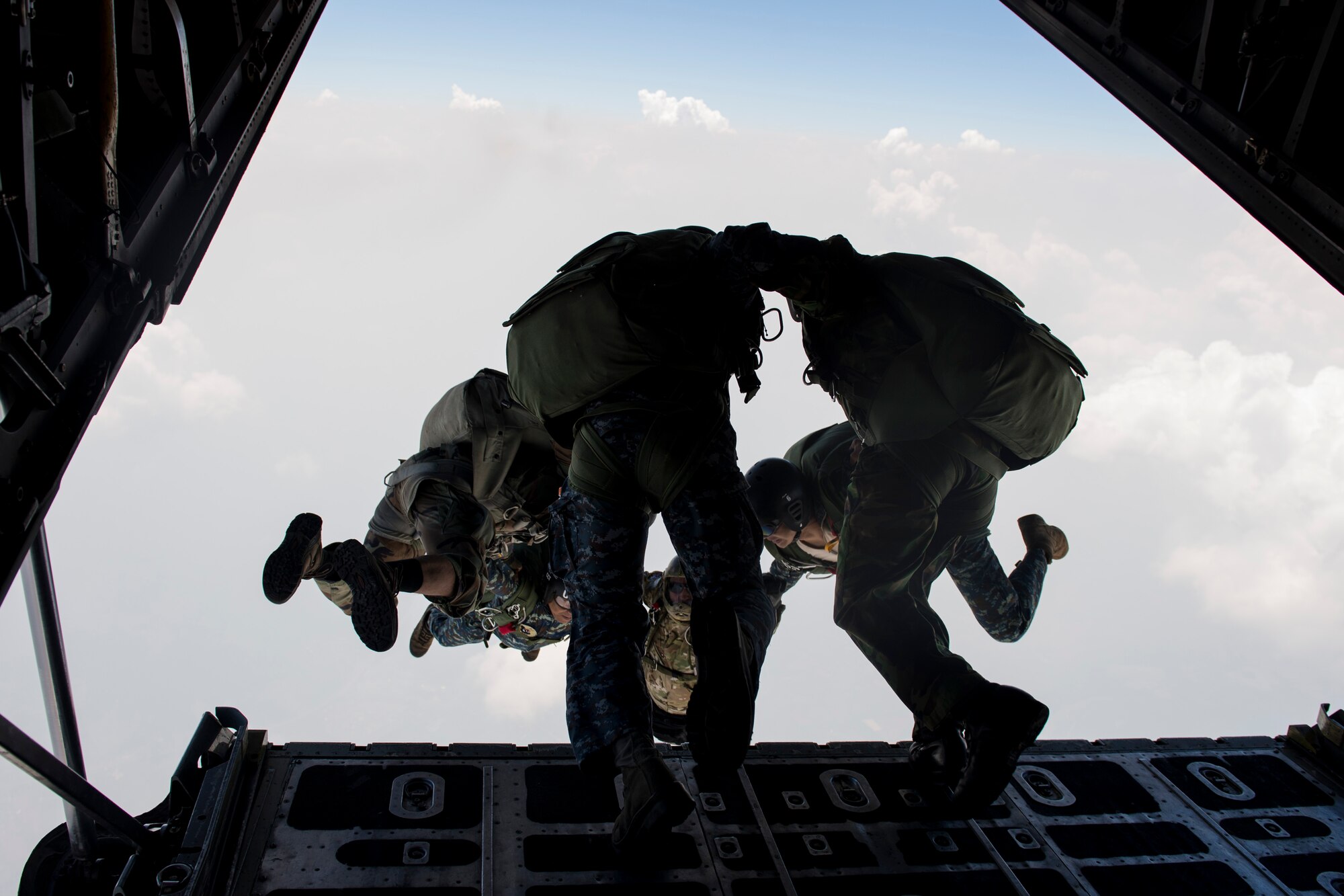 U.S. and Thai air forces conduct a High Altitude Low Opening jump from a U.S. C-130 during Exercise Cope Tiger 15 near Udon, Thailand, March 11, 2015. CT15 includes 22 total flying units and over 1,390 personnel from three countries and continues the growth of strong, interoperable and beneficial relationships within the Asia-Pacific region through integration of airborne and land-based command 