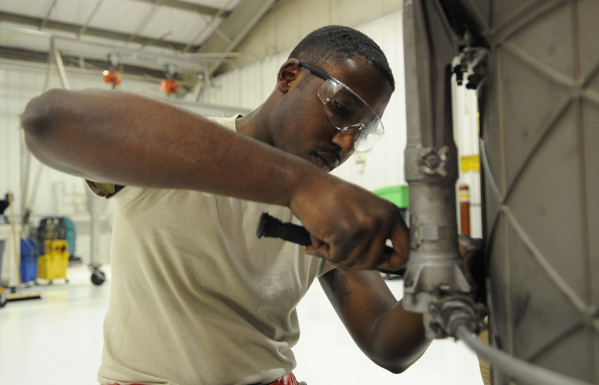 Airman 1st Class  Mitchell Dixon, 4th Component Maintenance Squadron aerospace propulsion journeyman, adjusts fasteners on an F-15E Strike Eagle engine augmenter module, March 9, 2015, at Seymour Johnson Air Force Base, North Carolina. Dixon was selected as a male vocalist for Tops in Blue and said he looks forward to giving back to military members around the world through performing arts. (U.S. Air Force photo/Senior Airman Ashley J. Thum)