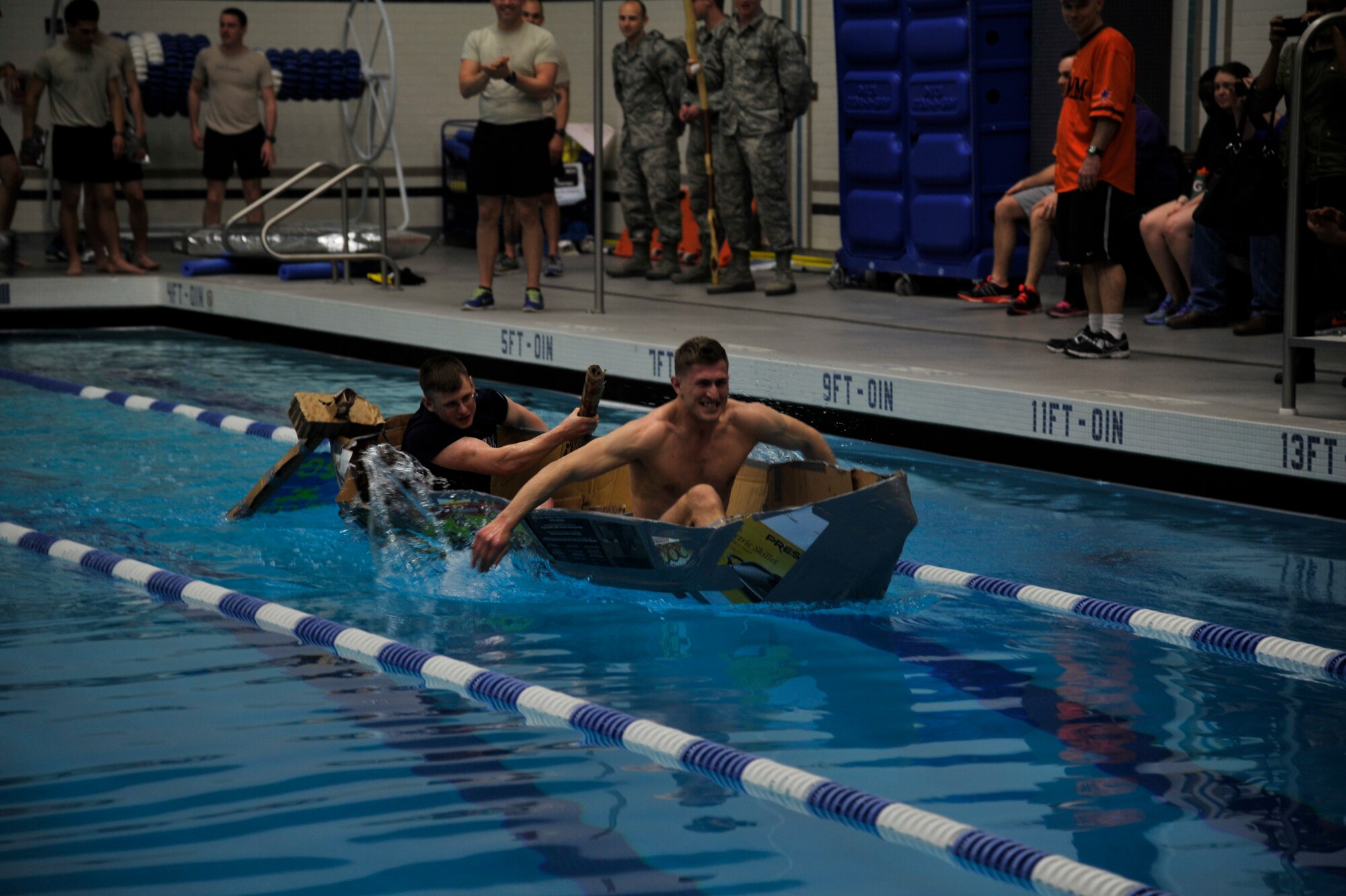 Airmen 1st Class Jackson Woods and Justin Bowens, both 92nd Contracting Squadron contract administrators, race their boat during Winter Sports Day, March 20, 2015, at Fairchild Air Force Base, Wash. The boat race was one of many sports Airmen participate in; other sports included volley ball, dodgeball, racquettball and disk golf. (U.S. Air Force photo/Airman 1st Class Taylor Bourgeous)