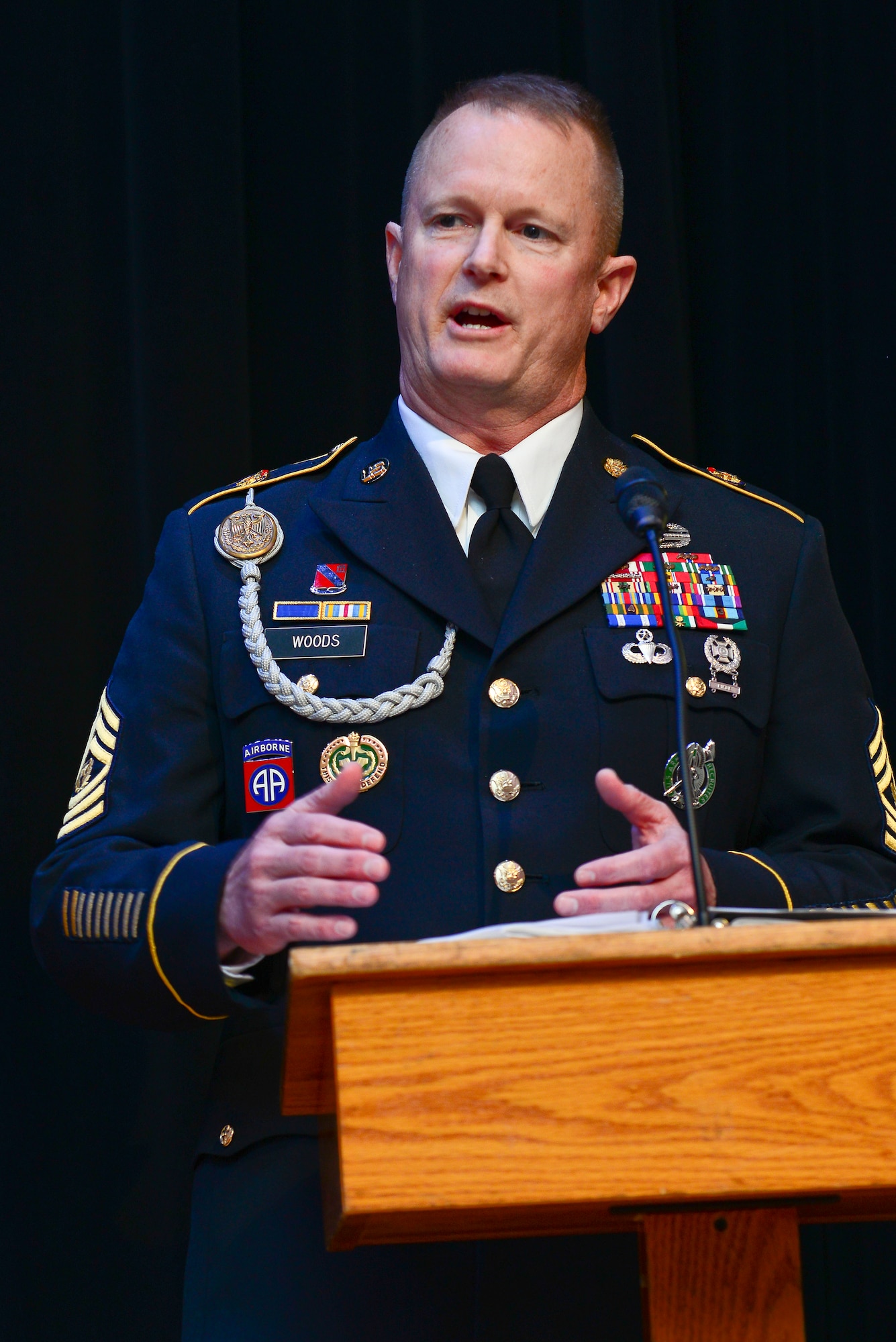 U.S. Army Command Sgt. Maj. Dennis Woods, U.S. Army Training and Doctrine Command Initial Military Training command sergeant major, spoke during the noncommissioned officer and Soldier of the year ceremony at Fort Eustis, Va., March 23, 2015. During the ceremony, Woods spoke to the crowd about the importance of competition and its impact on the military. (U.S. Air Force photo by Senior Airman Kimberly Nagle/Released) 