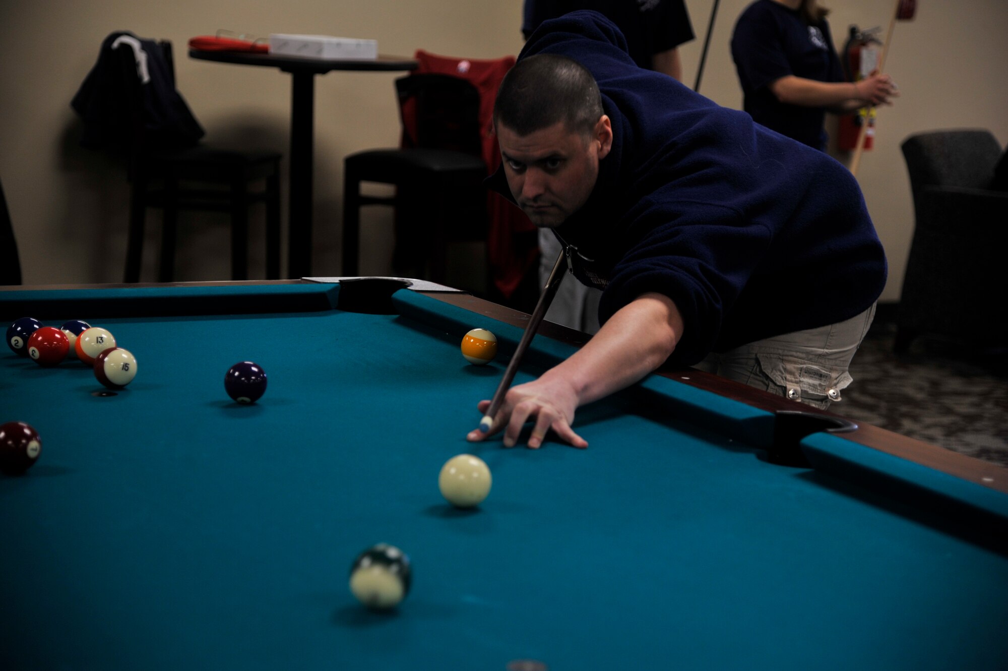 Staff Sgt. David Demilt, 92nd Comptroller Squadron financial services supervisor, plays pool during Winter Sports Day, March 20, 2015, in the Red Morgan Center at Fairchild Air Force Base, Wash. Winter Sports Day included 15 different sports and had more than 900 participants. (U.S. Air Force photo/Airman 1st Class Taylor Bourgeous)