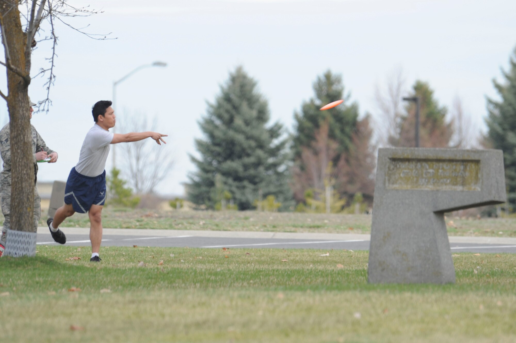 A participant throws a disc golf frisbee during Winter Sports Day, March 20, 2015, at Fairchild Air Force Base, Wash. Members competed in numerous events such ultimate football, cardboard boat races, dodgeball, racquet ball and relay races. (U.S. Air Force photo/Airman 1st Class Nicolo J. Daniello)