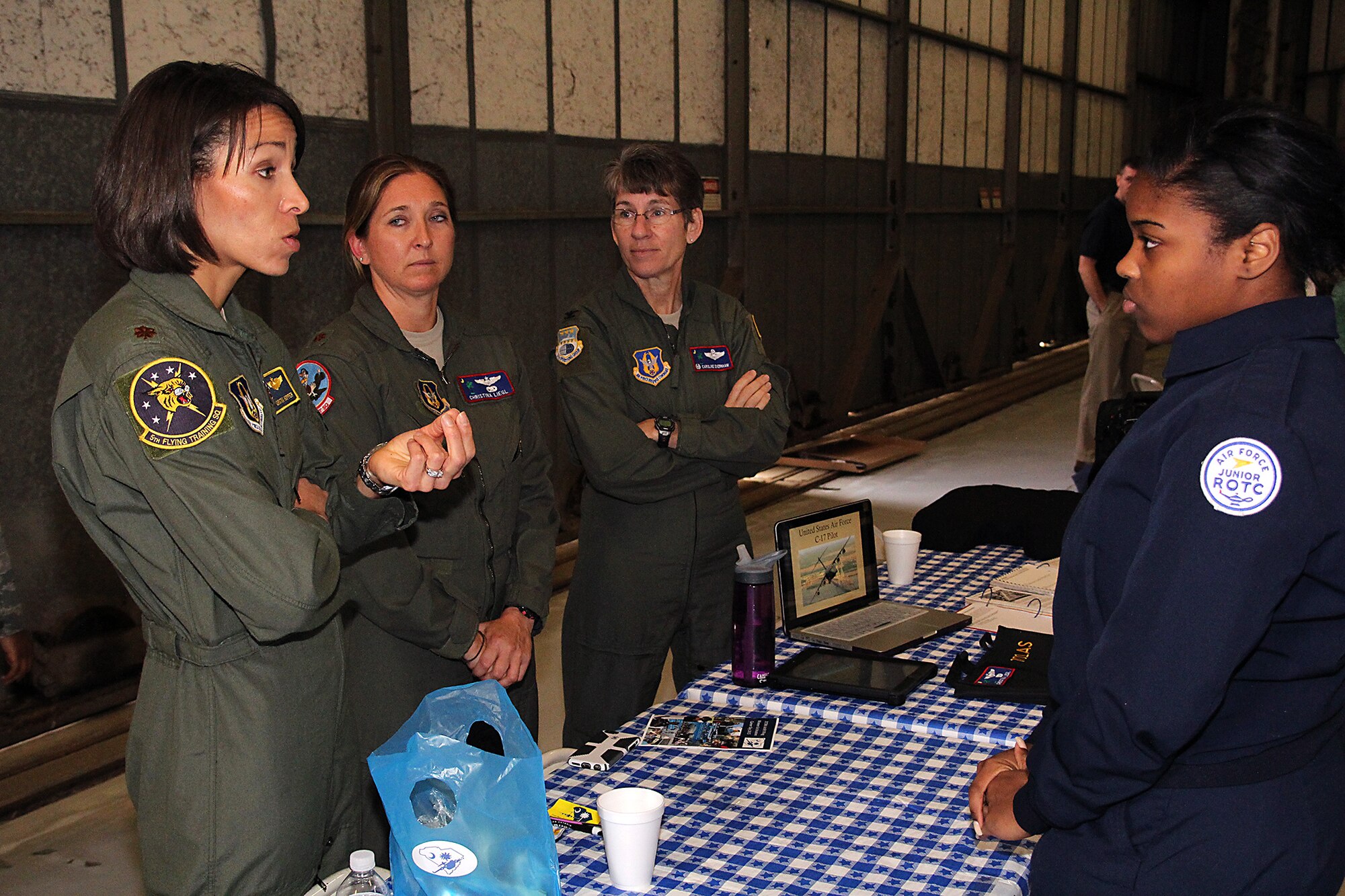 Maj. Christina "Thumper" Hopper (left), from the 71st Flying Training Wing at Vance Air Force Base, Oklahoma, speaks to Charleston area high school girls at the 8th Annual Joint Base Charleston Women in Aviation Career Day. Hopper was the first African-American female fighter pilot to fly combat missions during a major war. She shared stories of her overcoming adversity and challenges early in her life, and challenged the girls to be anything they want to be. (U.S. Air Force Photo / Michael Dukes)