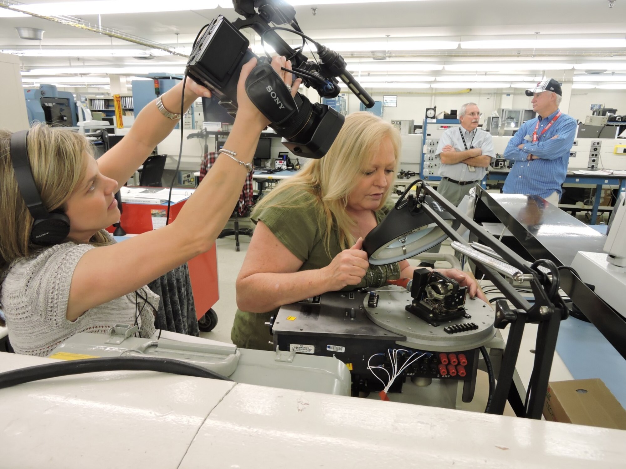 Susan Thompson, 566th Electronics Maintenance Squadron electronics mechanic, makes sure the circuitry is functioning properly in a gyroscope assembly. The 566th EMXS Gyro Shop will be featured on 13WMAZ's "Behind the Lines" segment airing on the March 26th Eyewitness News telecast at 6 p.m. (U.S. Air Force photo by Roland Leach)