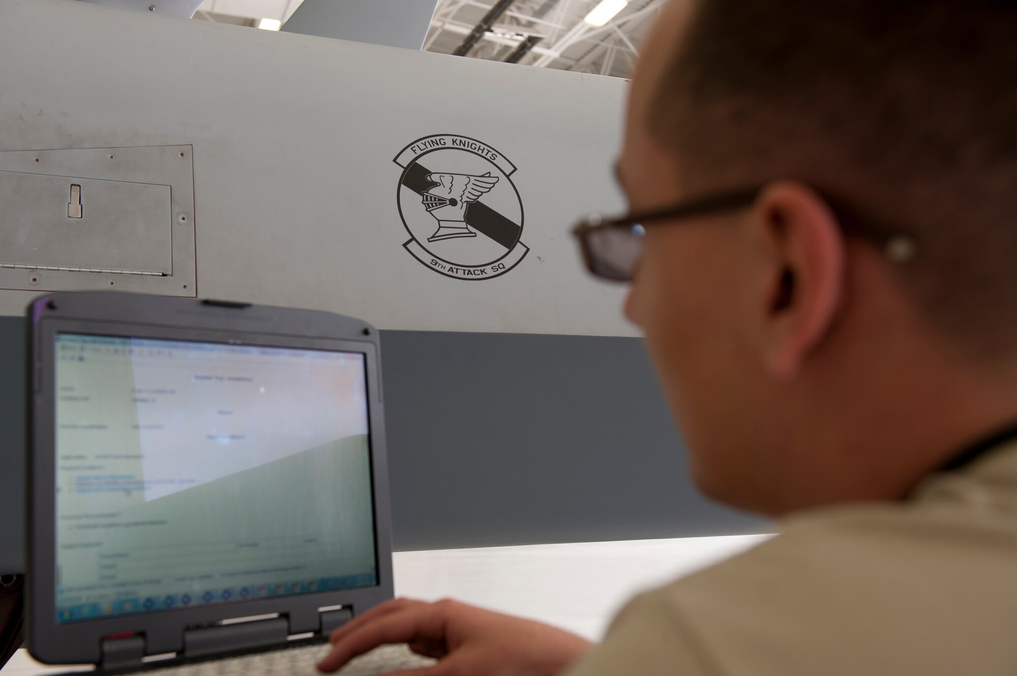 Senior Airman Peter May, 49th Aircraft Maintenance Squadron Avionic specialist journeyman, uses an electronic technical order to ensure all procedures are followed at Holloman Air Force Base, N.M. March 18, 2015. Electronic technical orders are step-by-step manuals explaining how to complete any maintenance or inspections required on the aircraft. (U.S. Air Force photo by Staff Sgt. E’Lysia A. Wray/Released)