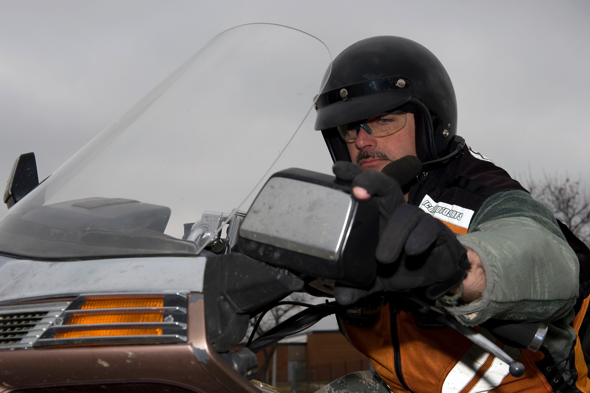 Tech. Sgt. John Thompson, 434th Aircraft Maintenance Squadron crew chief, adjusts his motorcycle mirror before embarking on a ride at Grissom Air Reserve Base, Ind., March 20, 2015. Thompson has been riding for 33 years and uses his experience and training to educate other riders. (U.S. Air Force photo/Tech. Sgt. Benjamin Mota)