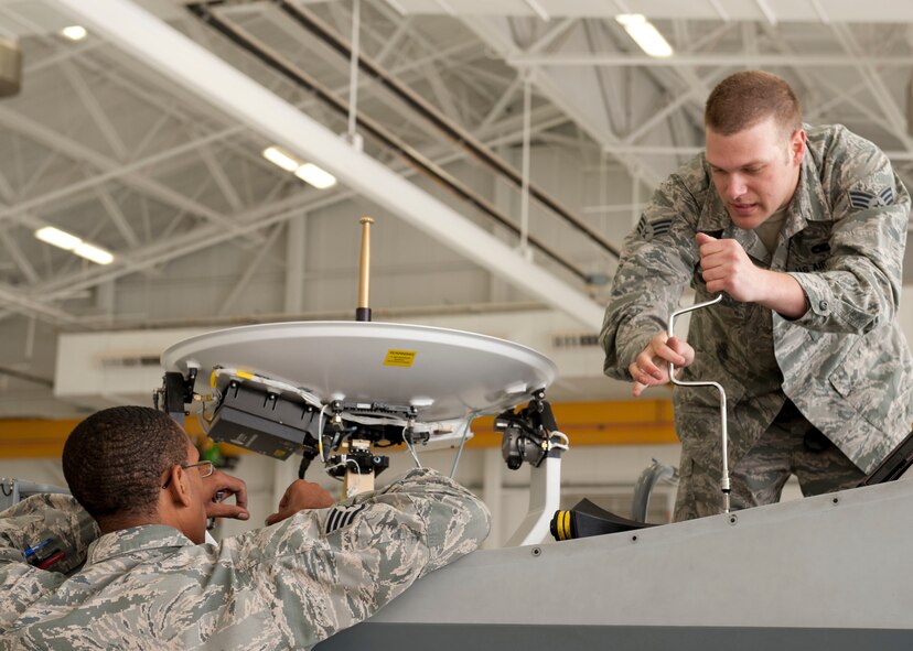 Staff Sgt. Justin Wray, 49th Aircraft Maintenance Squadron Avionic specialist craftsman, and Senior Airman Jacob Beilke, 49th Aircraft Maintenance Squadron Avionic specialist journeyman, work together to complete routine maintenance on a MQ-9 Reaper at Holloman Air Force Base, N.M. March 18, 2015. Routine maintenance is completed to ensure the integrity of the aircraft is at its peak of performance. (U.S. Air Force photo by Staff Sgt. E’Lysia A. Wray/Released)
