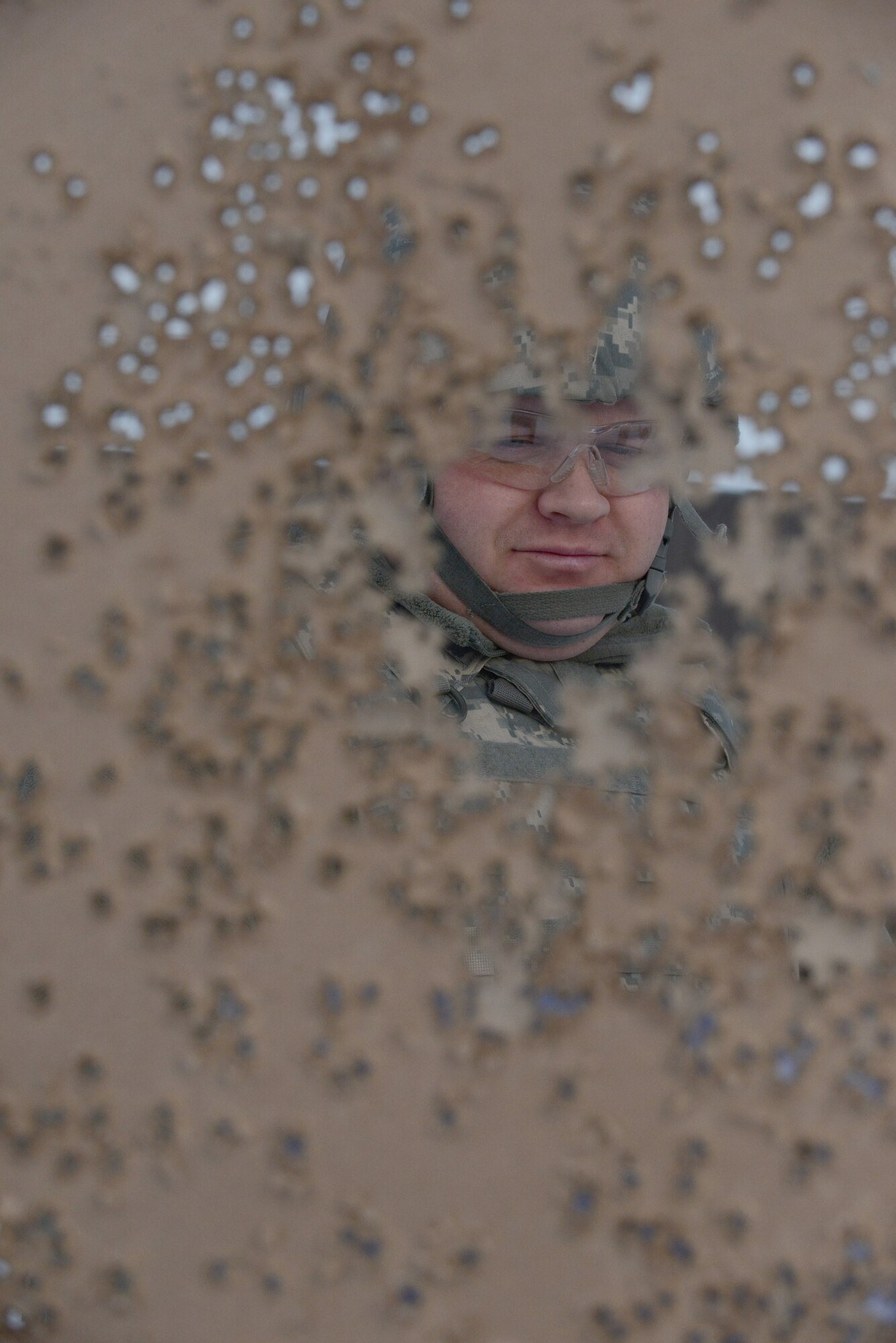 U.S. Air Force Staff Sgt. Justin Friedli, the 354th Civil Engineer Squadron operations manager, checks his target for hits at the Combat Arms Training and Maintenance outdoor range Feb. 12, 2015, Eielson Air Force Base, Alaska. Friedli attended an M4 requalification course.  (U.S. Air Force photo by Senior Airman Ashley Taylor/Released)