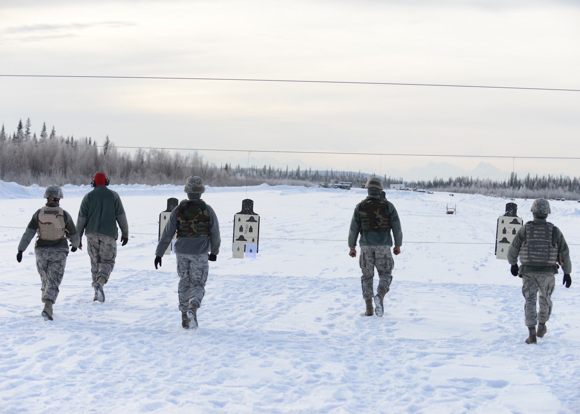 U.S. Airmen check targets for hits at the Combat Arms Training and Maintenance outdoor range Feb. 12, 2015, Eielson Air Force Base, Alaska. Airmen attended an M4 requalification course.  (U.S. Air Force photo by Senior Airman Ashley Taylor/Released)