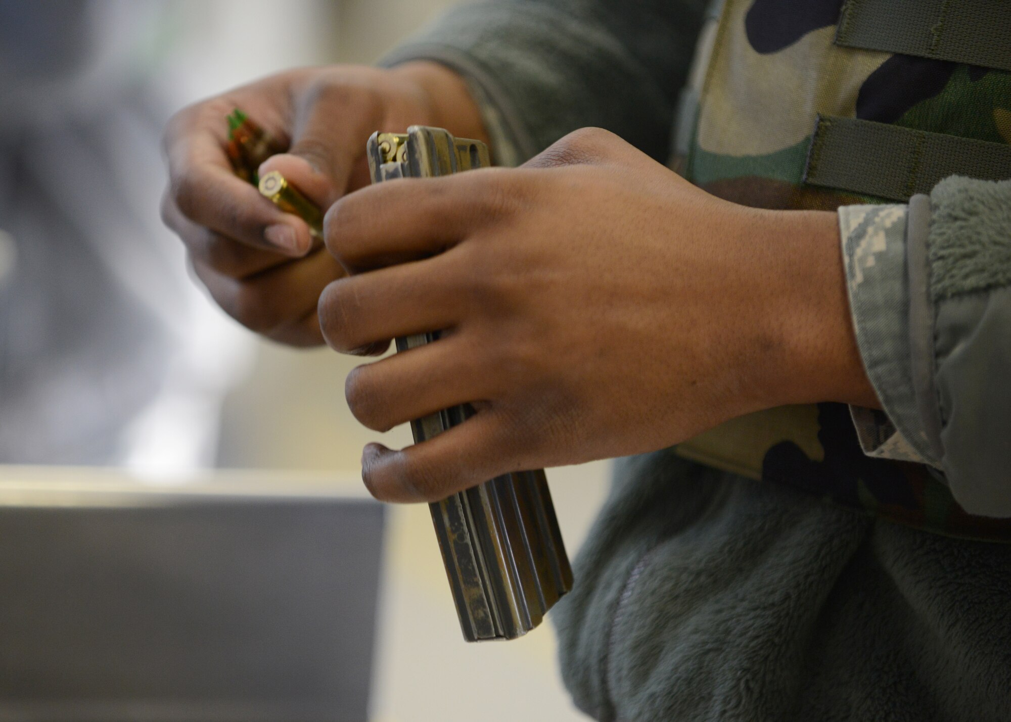 A U.S. Airman loads rounds into an M4 carbine magazine at the Combat Arms Training and Maintenance facility Feb. 12, 2015, Eielson Air Force Base, Alaska. Airmen attended an M4 requalification course.  (U.S. Air Force photo by Senior Airman Ashley Taylor/Released)