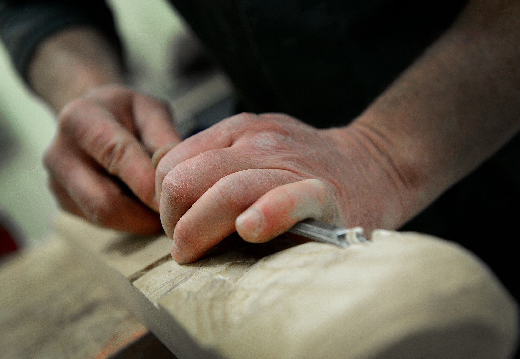 Stefano De Bortoli, 31st Force Support Squadron wood hobby shop manager, chisels a piece of wood March 24, 2015, at Aviano Air Base, Italy. The shop is part of the arts and crafts center and is open Tuesday through Saturday. (U.S. Air Force photo by Senior Airman Matthew Lotz/Released)