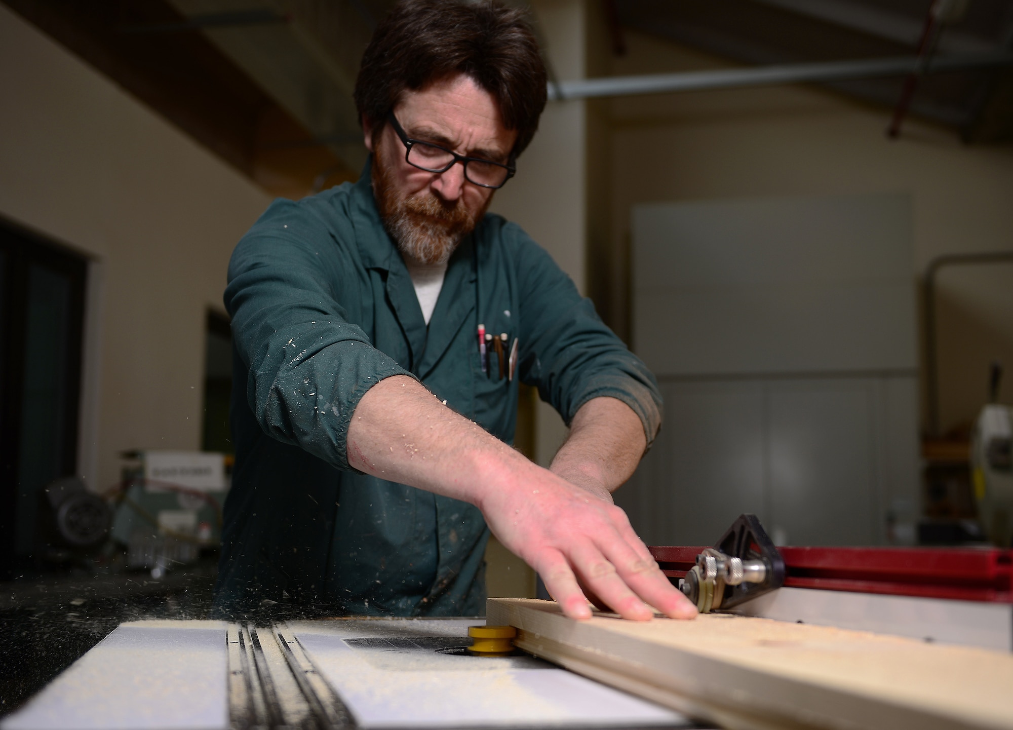 Stefano De Bortoli, 31st Force Support Squadron wood hobby shop manager, uses a router on a piece of wood, March 24, 2015, at Aviano Air Base, Italy. The shop is part of the arts and crafts center and is open Tuesday through Saturday. (U.S. Air Force photo by Senior Airman Matthew Lotz/Released)