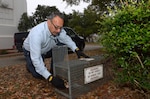 Al Salazar, 502nd Civil Engineer Squadron pest management technician, sets up a small-animal trap March 17 on Joint Base San Antonio-Randolph. (U.S. Air Force photo by Johnny Saldivar)
