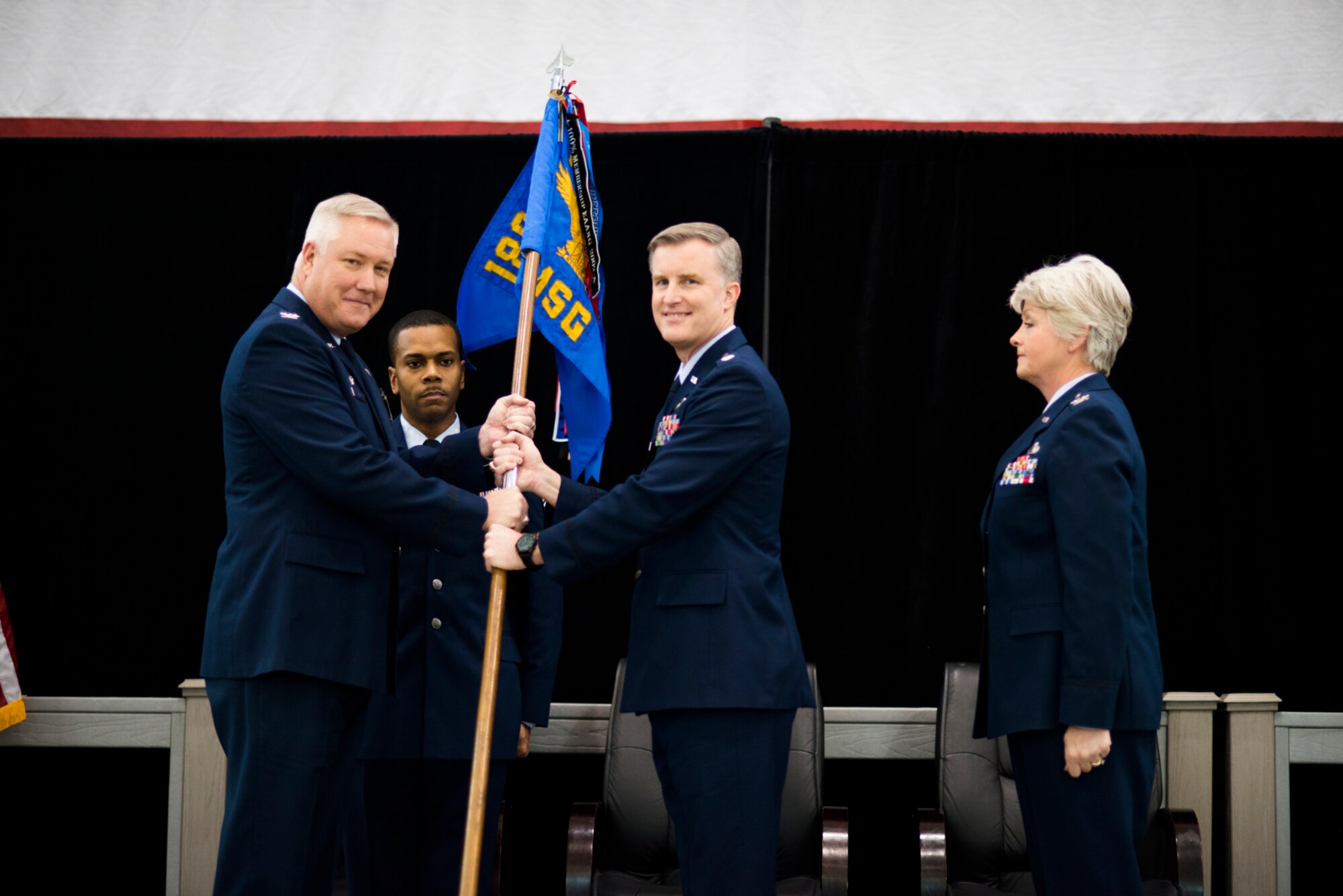 Col. Rob Ator, 189th Airlift Wing commander, passes the guideon to Lt. Col. Don Clark as he takes command of the 189th Mission Support Group at hangar 207 on Sunday Mar. 8, 2015. Also pictured (from L to R) is Senior Master Sgt. Jamar Bennett, 189th Mission Support Group first sergeant and former Mission Support Group commander, Col. Tamhra Huthens-Frye.
