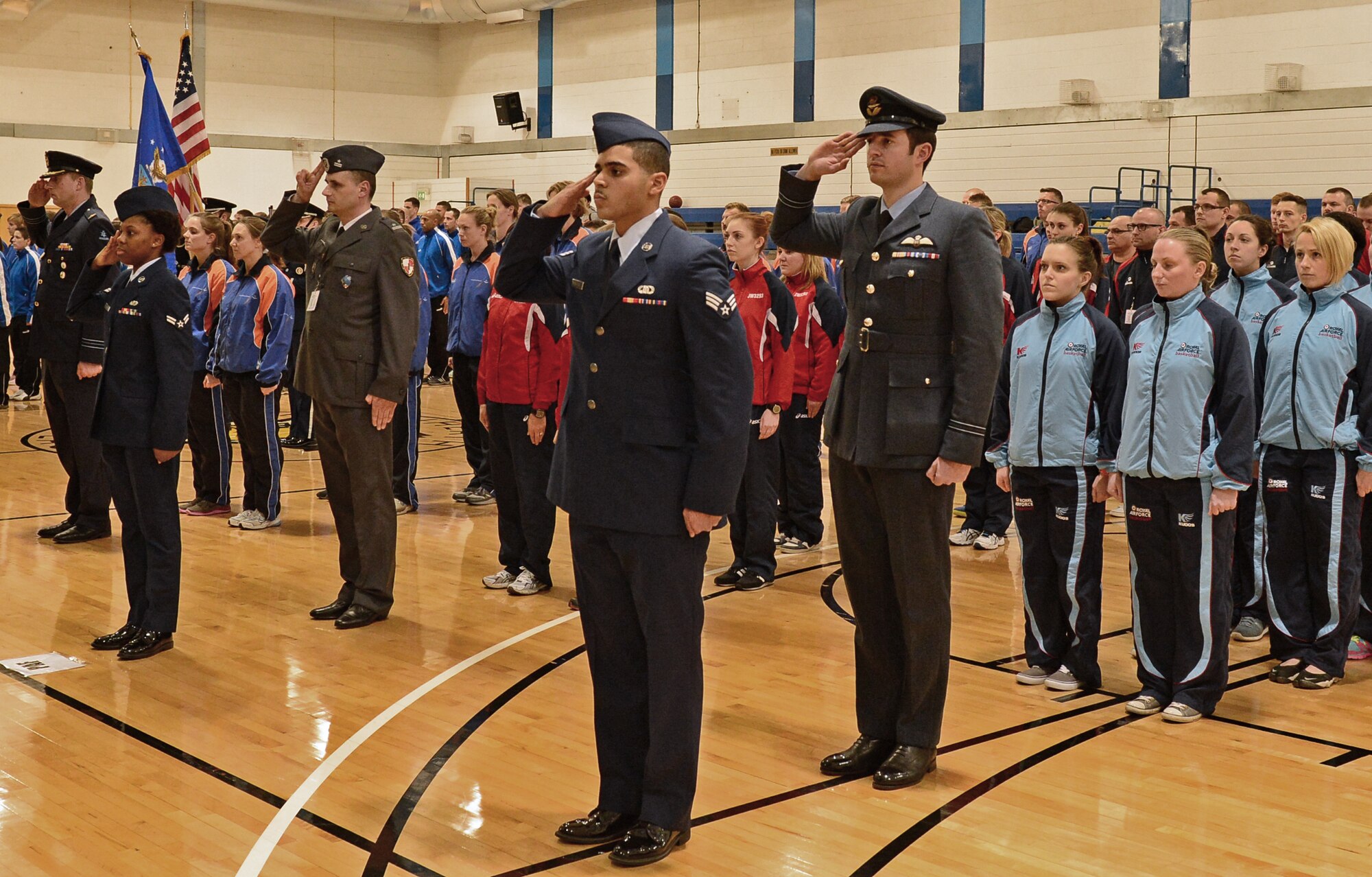 Participating members of NATO Inter-Nation Sports Championship teams  stand as national anthems play during the opening ceremony at Royal Air Force Lakenheath, England, March 24, 2015. The competition reinforces the mutual respect and goodwill that exist between NATO nations. (U.S. Air Force photo by Airman 1st Class Erin R. Babis/Released)