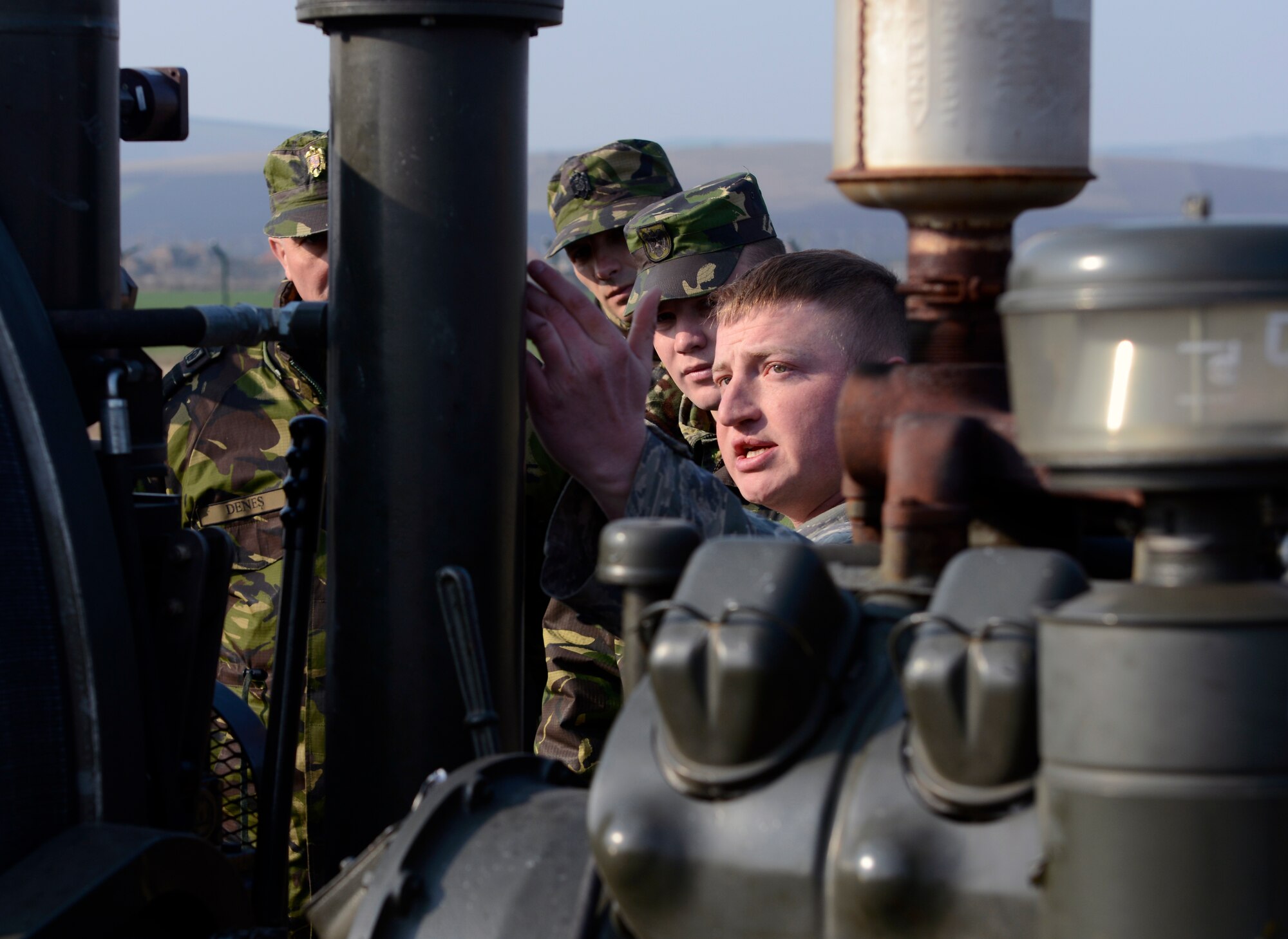 Staff Sgt. Aaryn Meeds, 435th Construction and Training Squadron power production technician, reviews specific components of the mobile aircraft arresting system during Dacian Warhawk, a two-week training mission designed to increase the interoperability between U.S. and Romanian air forces,  at Campia Turzii, Romania, March 24, 2015. Meeds and his team taught the Romanian airmen the basic functions of the MAAS in order to improve their knowledge and understanding of the system for future use in combined operations. (U.S. Air Force photo/Staff Sgt. Kris Levasseur)