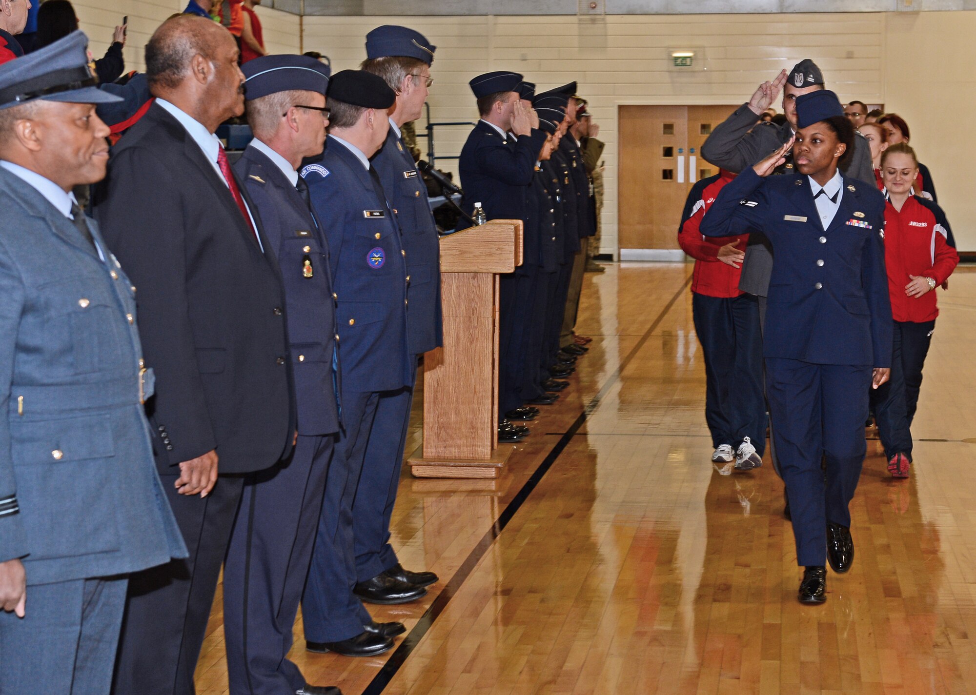 U.S. Air Force Airman 1st Class Marshae Wiggins, 48th Force Support Squadron, leads the Polish Air Force basketball teams at the Inter-Nation Sports Championship opening ceremony at Royal Air Force Lakenheath, England, March 24, 2015. This event brings together the contributing nations within NATO’s Allied Air Command in an atmosphere of friendly sporting competition. (U.S. Air Force photo by Airman 1st Class Erin R. Babis/Released)