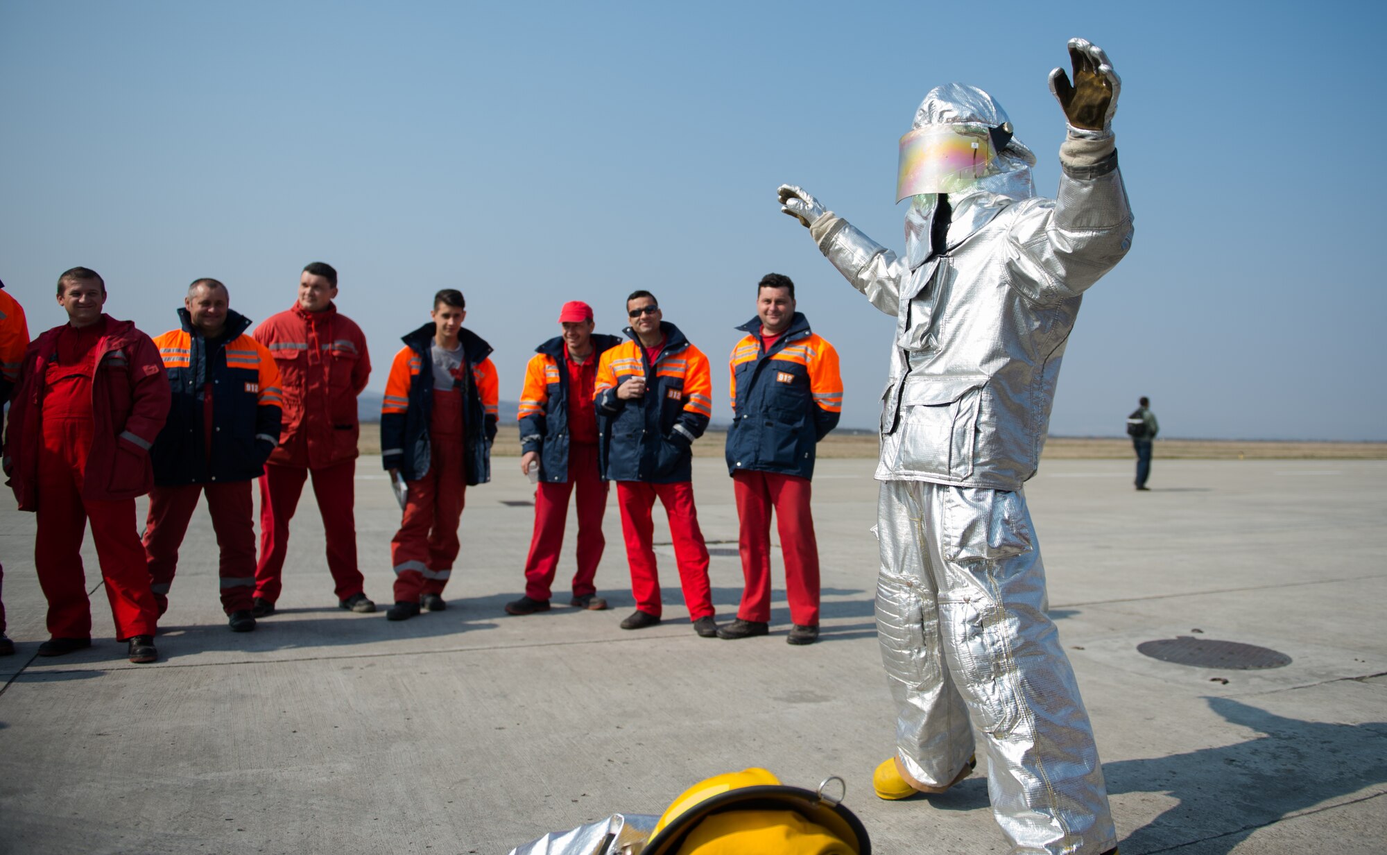 Airman 1st Class Nathan Miller, 52nd Civil Engineer Squadron firefighter, showcases the U.S. fire equipment to Romanian firefighters at Campia Turzii, Romania, March 23, 2015. Air advisers from the 435th Air Ground Operations Wing hosted events to learn from each other and build relationships during Dacian Warhawk, a two-week training mission designed to increase the interoperability between the two nations. (U.S. Air Force photo/Staff Sgt. Armando A. Schwier-Morales)