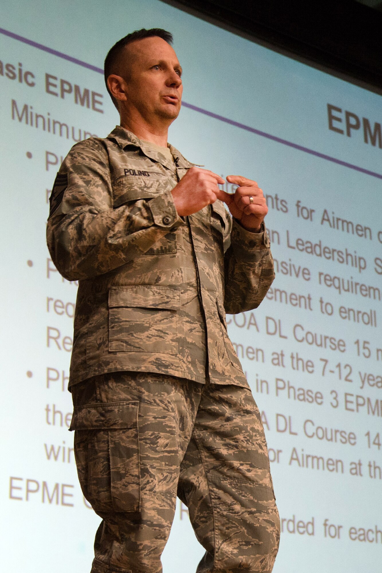 Command Chief Master Sgt. Craig A. Poling speaks to the enlisted force during all-call session at the base theater March 20. During the all-call, Poling discussed enlisted topics such as the Developmental Special Duty, enlisted evaluation system, Airmen Comprehensive Assessment and more. (U.S. Air Force photo by Mark Herlihy)