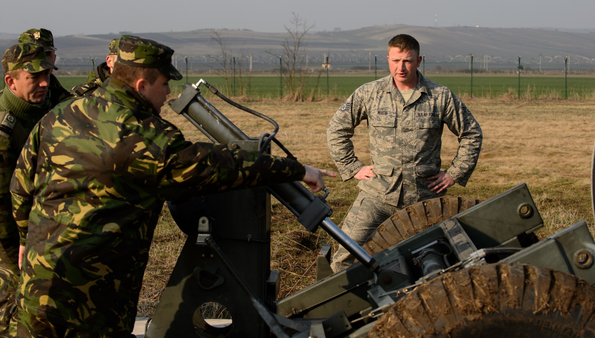 Staff Sgt. Aaryn Meeds, 435th Construction and Training Squadron power production technician, listens to Romanian airmen during Dacian Warhawk, a two-week training mission designed to increase the interoperability between U.S. and Romanian air forces, at Campia Turzii, Romania, March 24, 2015. Meeds and his team taught the Romanian airmen the basic functions of the MAAS in order to improve their knowledge and understanding of the system for future use in combined operations. (U.S. Air Force photo/Staff Sgt. Armando A. Schwier-Morales) 
